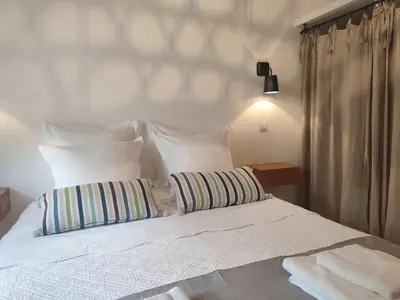 a white bed with two pillows on top of it at Les Bergeries de Piazzagina in Piediquarciu