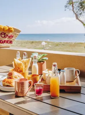 a table with a tray of breakfast food and juice at Oro Biancu in Lucciana