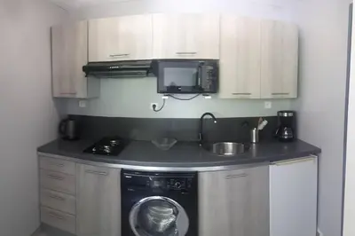 a kitchen with a washing machine and a sink at Pavillon T2 proche ville dans petite résidence in Cuttoli-Corticchiato