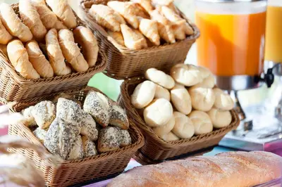 a bunch of baskets filled with different types of bread at Holiday Inn Express Ajaccio by IHG in Ajaccio
