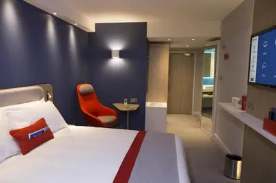a hotel room with a bed and a tv at Holiday Inn Express Ajaccio by IHG in Ajaccio