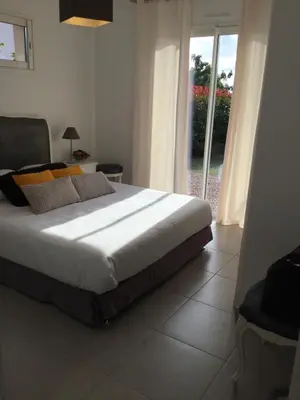 a bedroom with a bed and a large window at Mini-villa mitoyenne de type F2 proche Golfe de Lava in Appietto