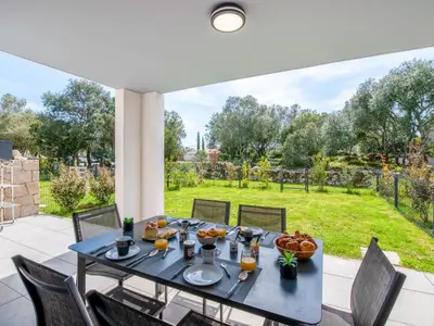 a table with food on it on a patio at Apartment Domaine d'Arca-2 by Interhome in Porto-Vecchio