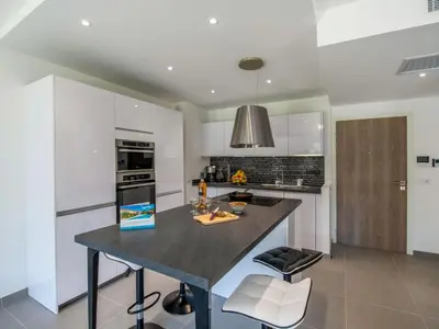 a kitchen with a large island in the middle at Apartment Domaine d'Arca-2 by Interhome in Porto-Vecchio