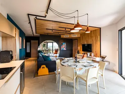 a dining room and kitchen with a table and chairs at Apartment Stanatura-1 by Interhome in Porto-Vecchio