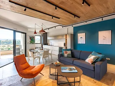 a living room with a couch and a table at Apartment Stanatura-1 by Interhome in Porto-Vecchio