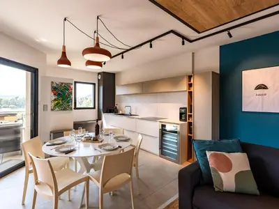 a dining room and kitchen with a table and chairs at Apartment Stanatura-1 by Interhome in Porto-Vecchio