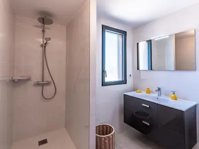 a bathroom with a sink and a shower at Apartment Stanatura-1 by Interhome in Porto-Vecchio