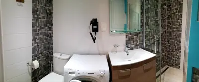 a bathroom with a toilet and a sink and a phone at Studio centre ville in Ajaccio