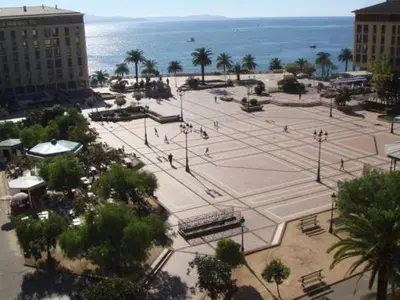 a large park with palm trees and the ocean at Studio centre ville in Ajaccio