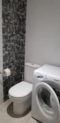 a bathroom with a toilet and a washing machine at Studio centre ville in Ajaccio