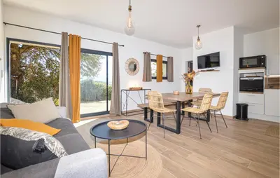 a living room with a couch and a table at 2 Bedroom Cozy Home In Pila Canale in Pila-Canale