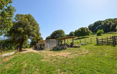 a small house in a field with a fence at 2 Bedroom Cozy Home In Pila Canale in Pila-Canale