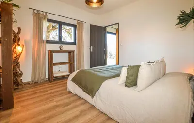 a bedroom with a bed and a large window at 2 Bedroom Cozy Home In Pila Canale in Pila-Canale
