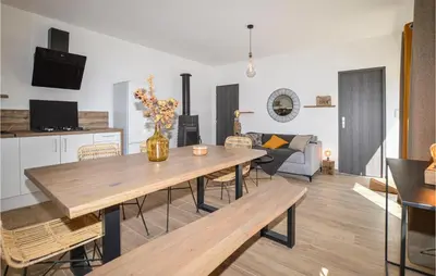 a living room with a table and a couch at 2 Bedroom Cozy Home In Pila Canale in Pila-Canale