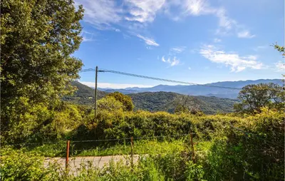 a fence with a view of mountains in the distance at 2 Bedroom Cozy Home In Pila Canale in Pila-Canale