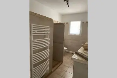 a bathroom with a sink and a toilet in a room at Suite spacieuse avec accès piscine in Ghisonaccia
