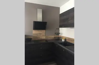 a kitchen with a sink and a counter top at Suite spacieuse avec accès piscine in Ghisonaccia