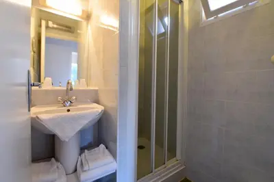 a bathroom with a sink and a shower at Résidence U Nebbiu in Olmeta-di-Tuda