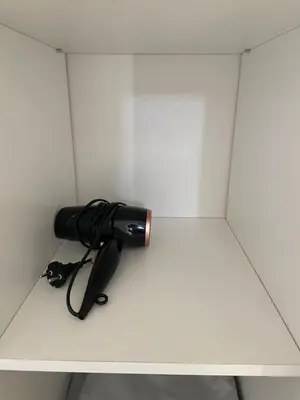 a black flashlight sitting on top of a shelf at Magnifique grand T3 refait à neuf en 2025 plein centre corte 13 cours paoli wifi écran plat lave linge 6 couchages in Corte