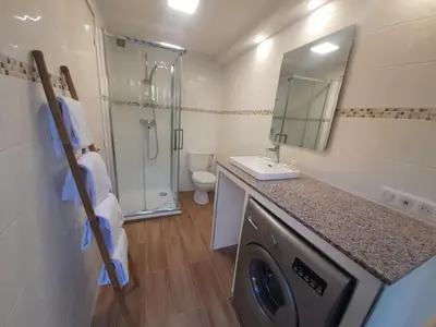 a bathroom with a sink and a washing machine at PORTICCIO BRILOC APPART DUPLEX à 150m de la plage. in Porticcio
