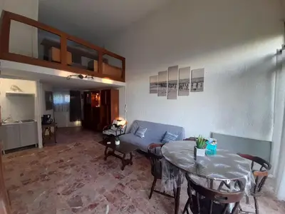 a living room with a couch and a table at PORTICCIO BRILOC APPART DUPLEX à 150m de la plage. in Porticcio