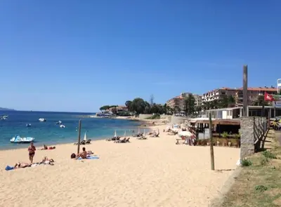 a group of people on a beach near the water at Ajaccio magnifique T2 neuf 40m2 avec balcon au Trottel 4 couchages wifi Clim parking plage à pieds 100m in Ajaccio