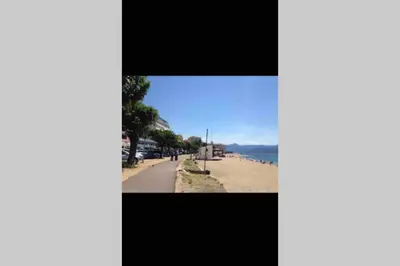 a view of a beach with a blue sky at Ajaccio magnifique T2 neuf 40m2 avec balcon au Trottel 4 couchages wifi Clim parking plage à pieds 100m in Ajaccio
