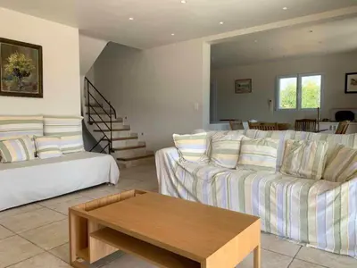 a living room with a couch and a coffee table at Les Villas de Lava in Appietto