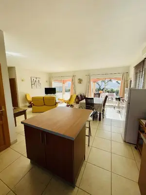 a kitchen and living room with a table at Superbe villa avec piscine vue mer, proche plage et Porticcio in Pietrosella