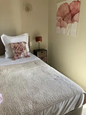 a bedroom with a bed and a lamp on a night stand at Superbe villa avec piscine vue mer, proche plage et Porticcio in Pietrosella