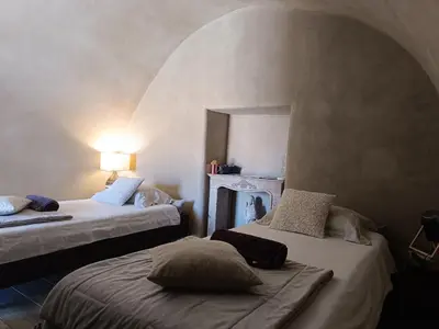 a room with two beds and a mirror at PARFUMU DI MACHJA in Santa-Lucia-di-Mercurio