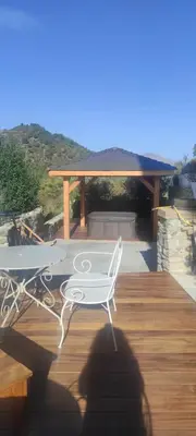 a white chair sitting on a deck with a table at PARFUMU DI MACHJA in Santa-Lucia-di-Mercurio
