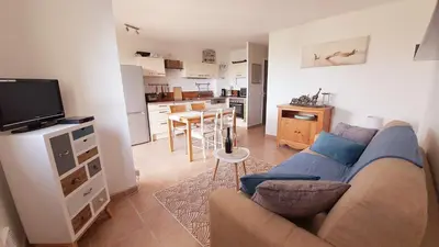 a living room with a couch and a kitchen at Porticcio - Casa Corsa in Porticcio