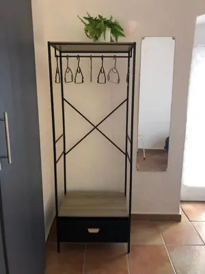 a black shelf with hangers and a mirror at BERNARDINI Emplacement exceptionnel in Sari Solenzara