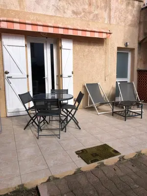 a patio with a table and chairs and a building at BERNARDINI Emplacement exceptionnel in Sari Solenzara
