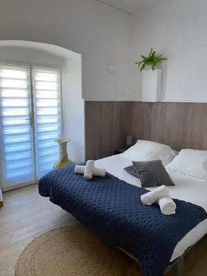 a bedroom with a large bed with towels on it at BERNARDINI Emplacement exceptionnel in Sari Solenzara