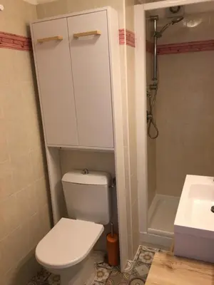 a bathroom with a white toilet and a sink at Corse Appartement vue mer - Linguizzetta - Marine de Bravone in Linguizzetta