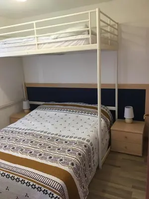 a bedroom with a bunk bed with a ladder at Corse Appartement vue mer - Linguizzetta - Marine de Bravone in Linguizzetta