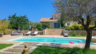 a house with a swimming pool in a yard at Très belle villa piscine jacuzzi grande propriété 10 pers in Belgodère