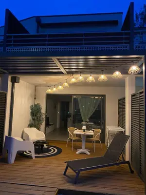 a patio with a table and chairs on a deck at Stella mare à porticcio in Porticcio