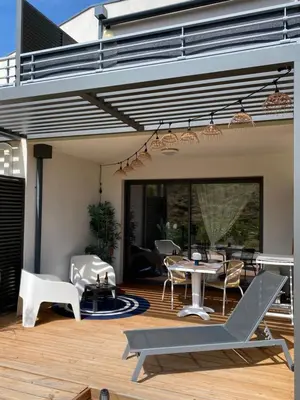 a patio with a table and chairs on a deck at Stella mare à porticcio in Porticcio