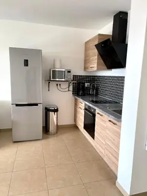 a kitchen with a refrigerator and a microwave at T2 de standing front de mer in Propriano