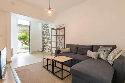 a living room with a couch and a table at Résidence Poggiole in San-Nicolao