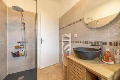 a bathroom with a sink and a mirror at Résidence Poggiole in San-Nicolao
