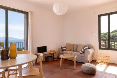 a living room with a couch and a table at Résidence Eole in Cargèse