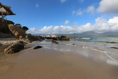 a beach with rocks and the ocean on a cloudy day at Appartement au calme à 15 minutes de Sartène in Foce