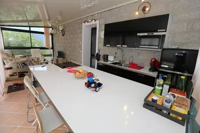a kitchen with a white counter top in a room at Appartement au calme à 15 minutes de Sartène in Foce
