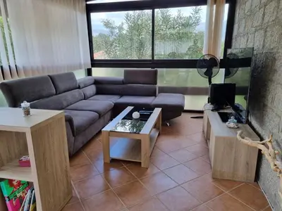 a living room with a couch and a table at Appartement au calme à 15 minutes de Sartène in Foce
