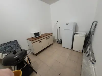 a small kitchen with a refrigerator and a microwave at Studio situé à 20 metres de la plage d Agosta Porticcio in Albitreccia